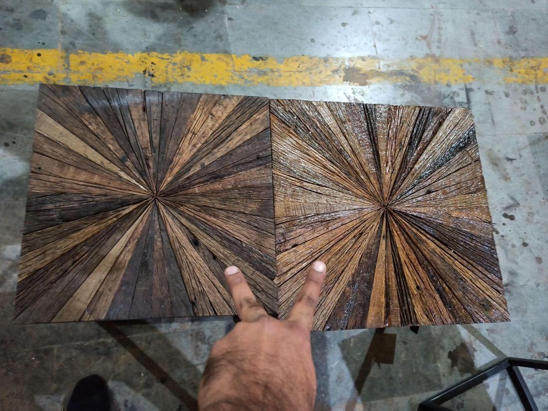 Two tops of the same nesting-table style laid side by side at inspection, showing a difference in size.