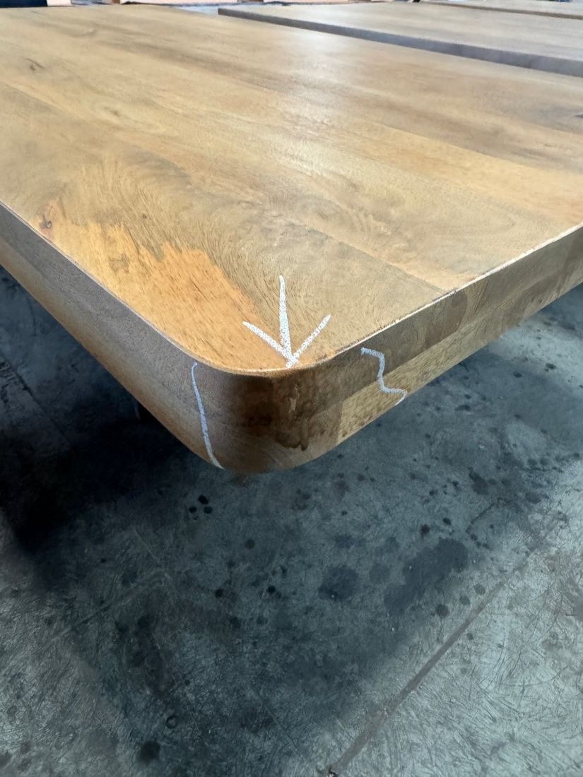 Stain soaked unevenly into the end grain at a rounded corner
