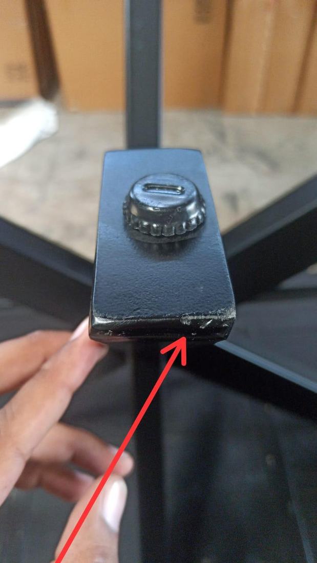 Chipped coating on a metal table base plate