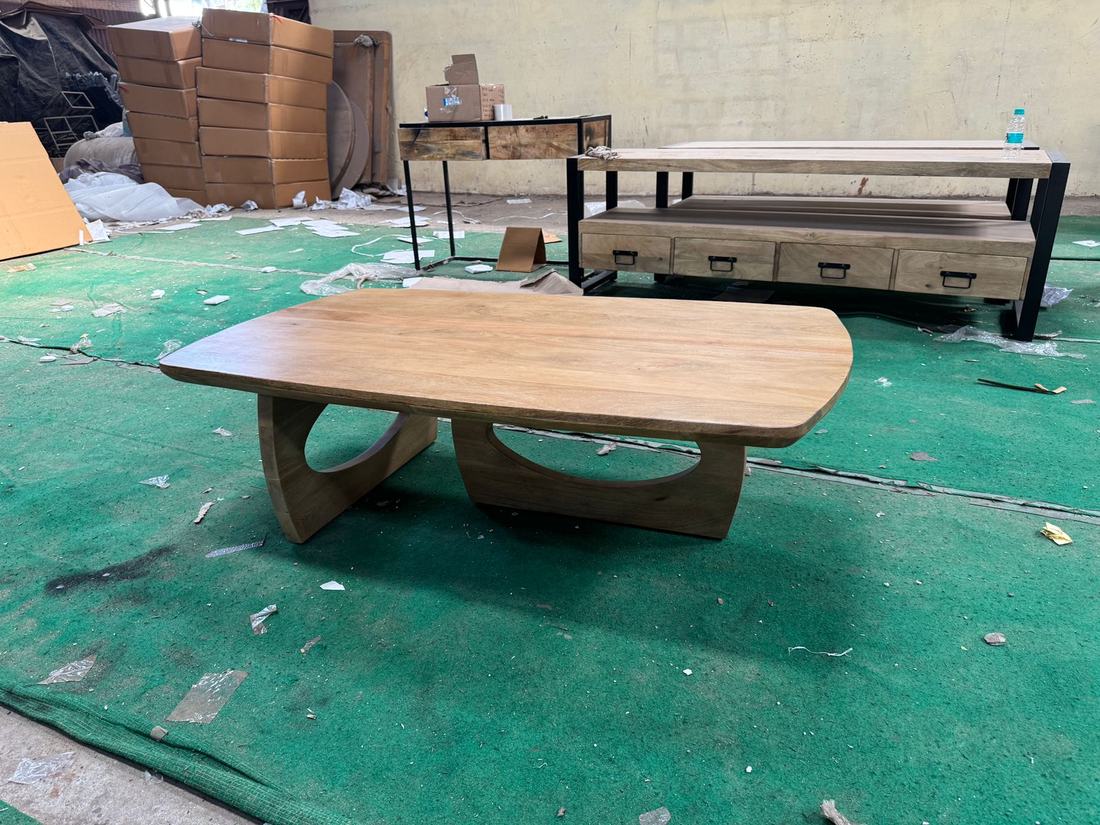 Solid wood coffee table with sculpted bases at inspection