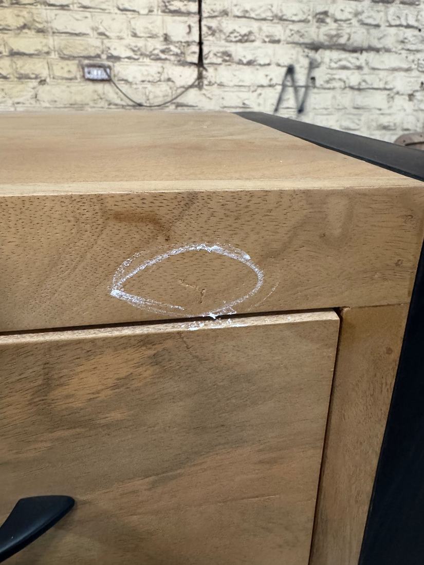 Small crack in the rail above a drawer, circled in chalk