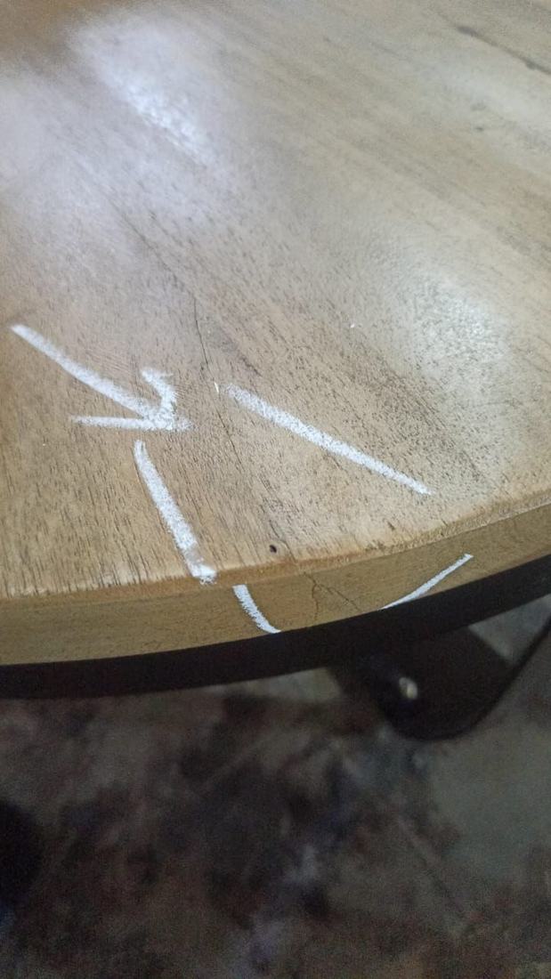 Crack running from the edge into a round top on a metal frame