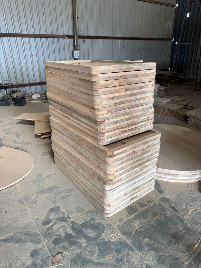 Glued-up tops stacked before finishing: the stage to check moisture and glue lines