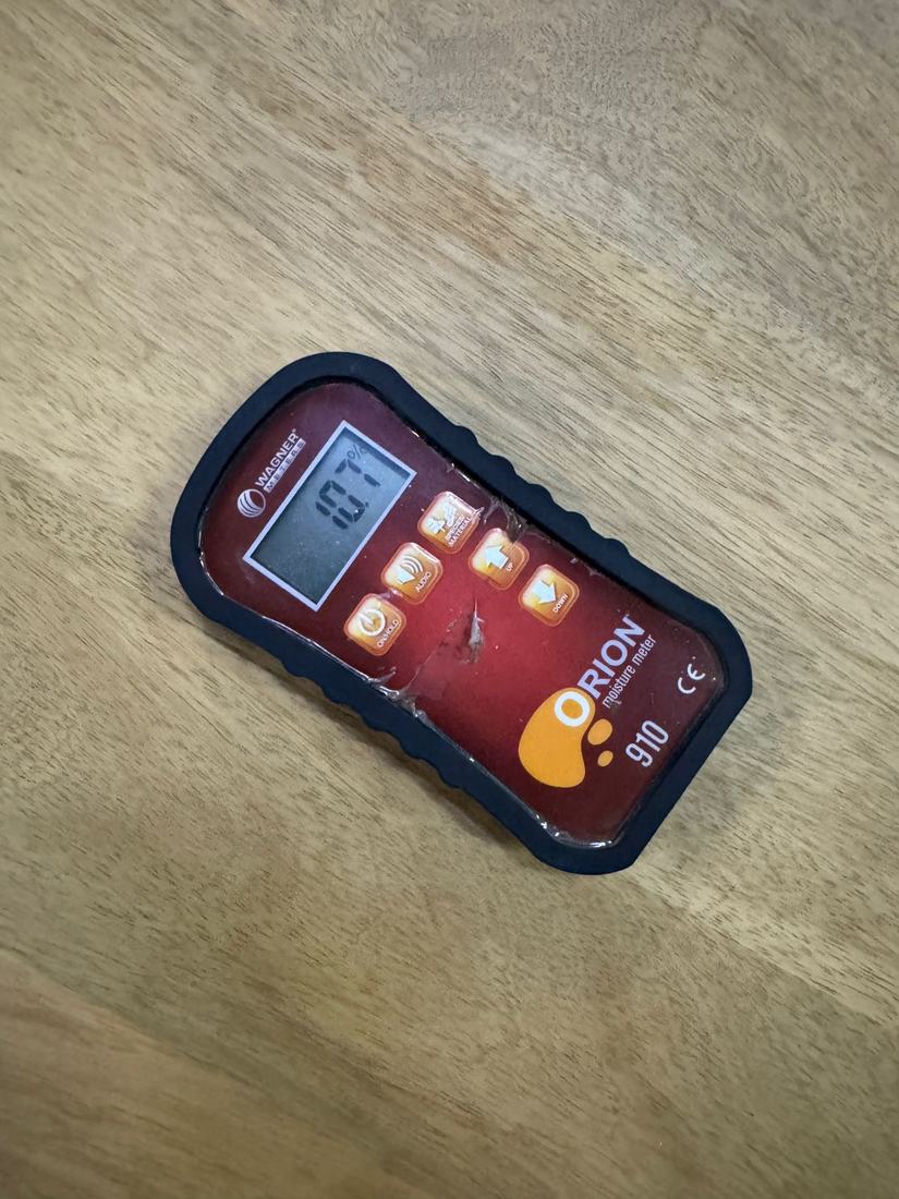 Moisture meter reading 10.1% on a solid wood top at inspection