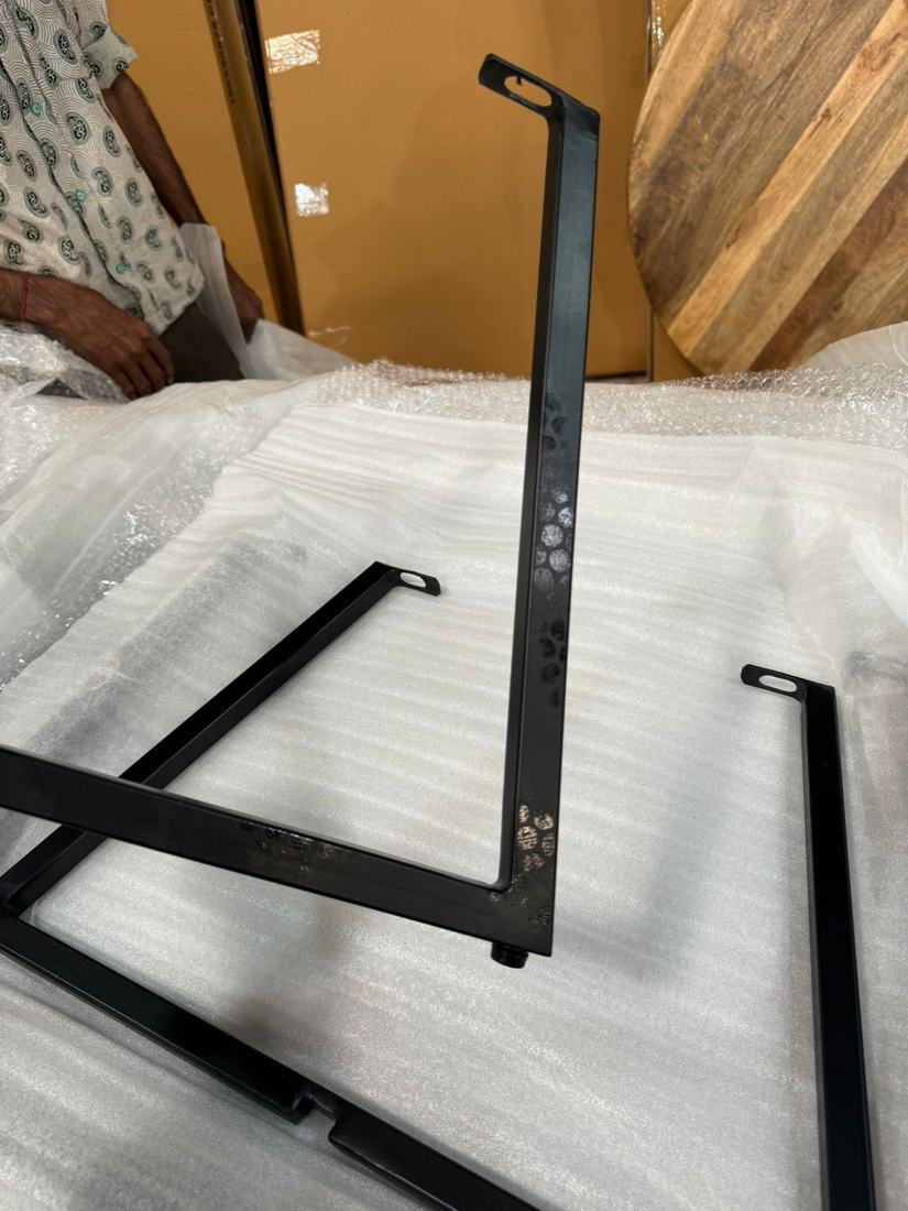 Patchy, uneven coating on black metal table legs