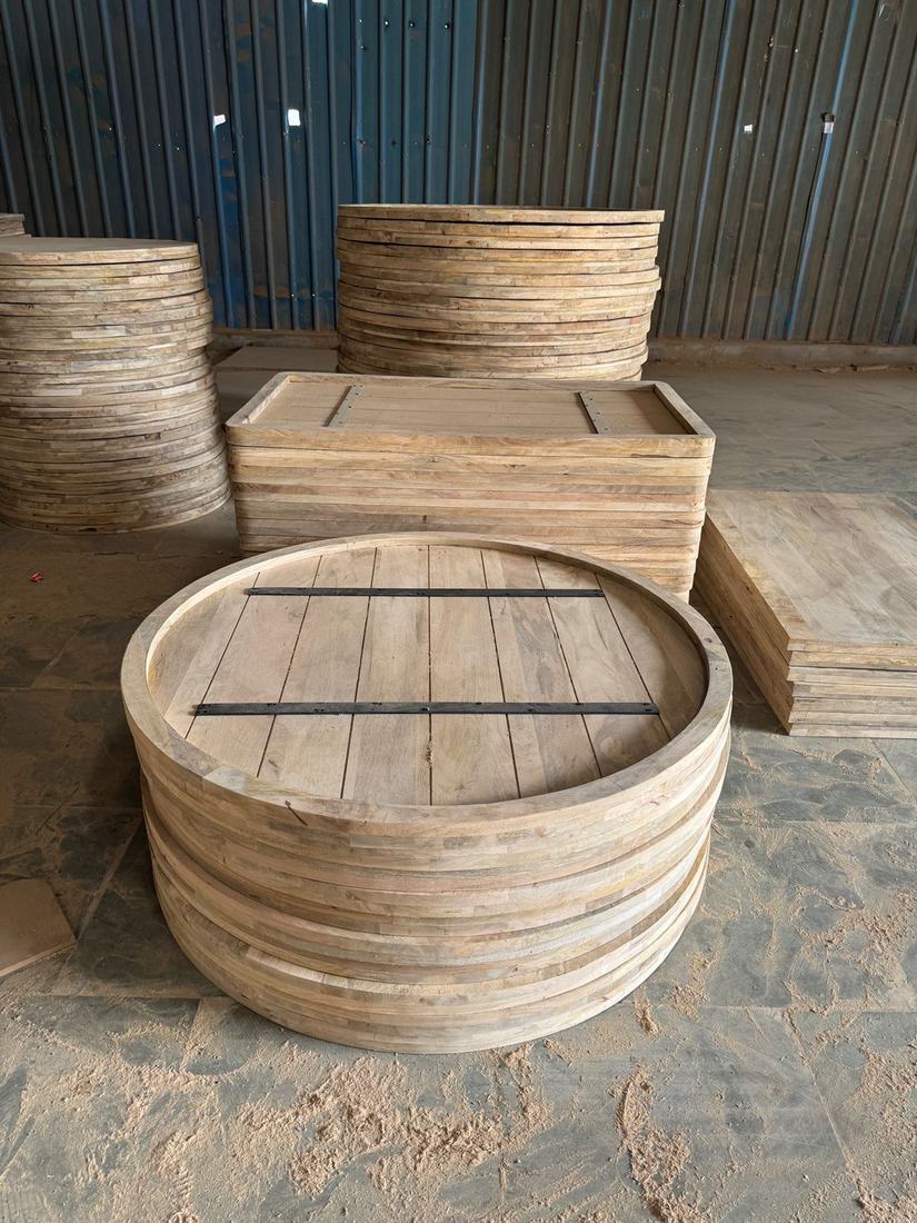 Unfinished round and rectangular tops with metal battens underneath, during production