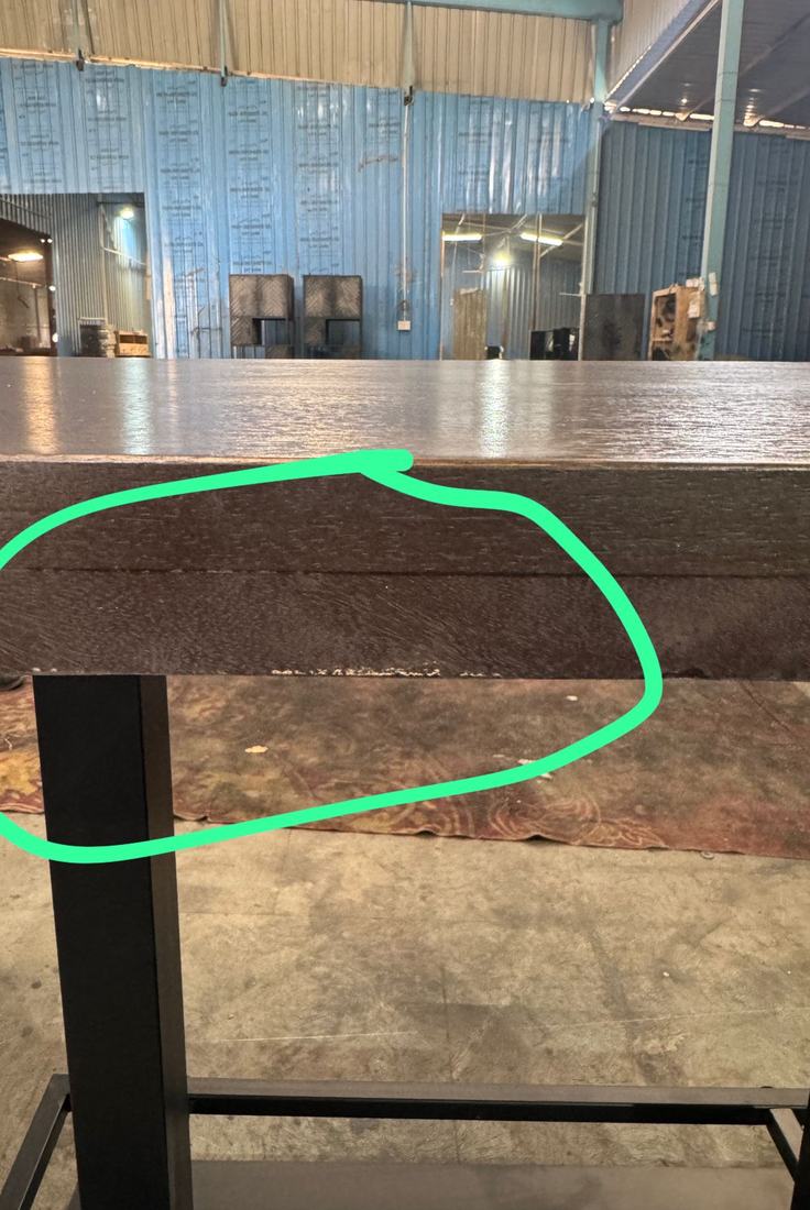 Glue line opening between the two layers of a thick top edge, with chipping along the underside