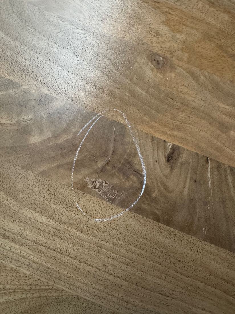 Torn grain at a board joint in a solid wood top, circled in chalk