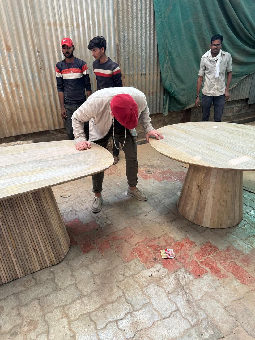 Checking tops on pedestal-base dining tables with the buyer