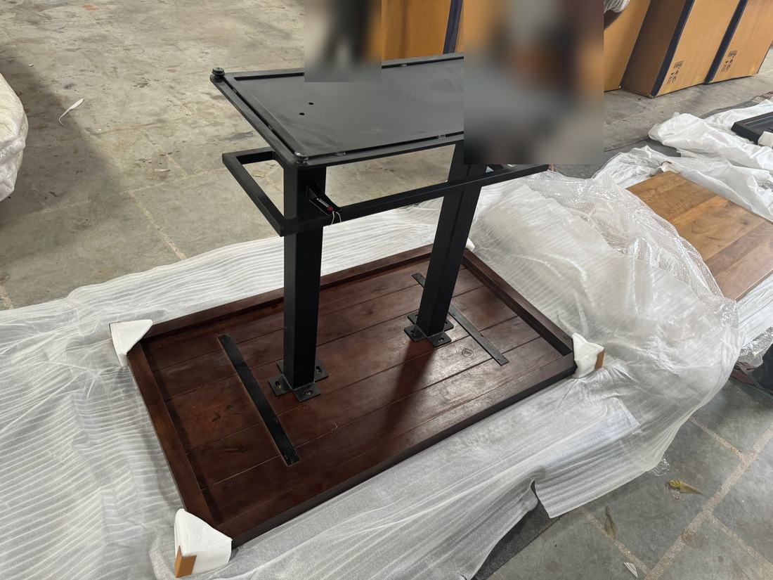 Metal base fitted to the underside of a top from the packed hardware, before packing