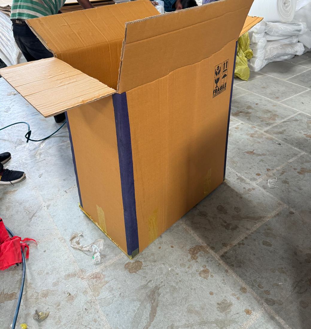 Export carton with taped edge protection and handling marks