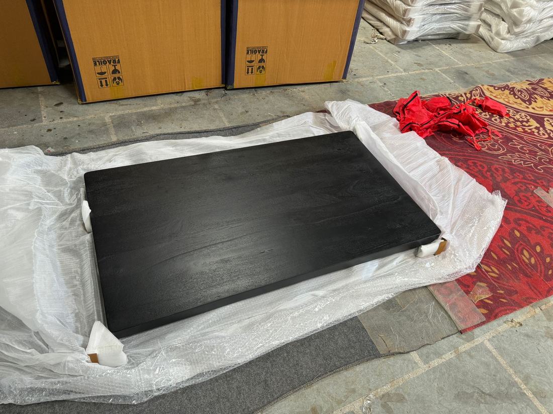 Corner protectors fitted to a black top before wrapping