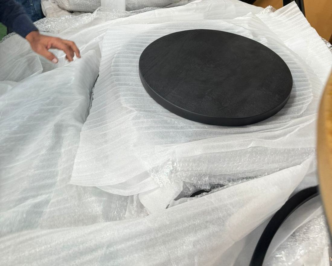 Round top laid on foam sheet for wrapping